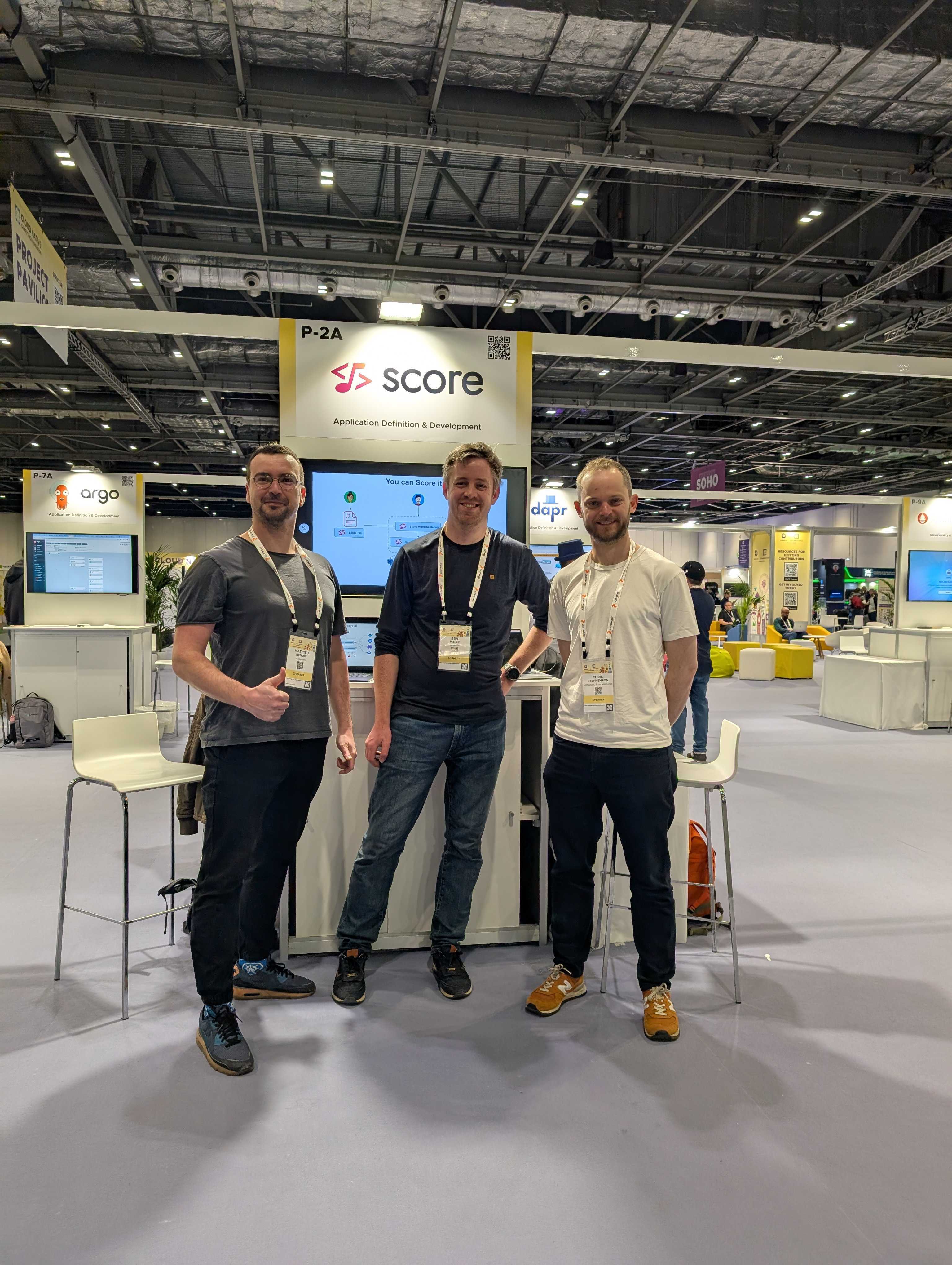Photos of the Score maintainers at the Score Kiosk at KubeCon EU 2025